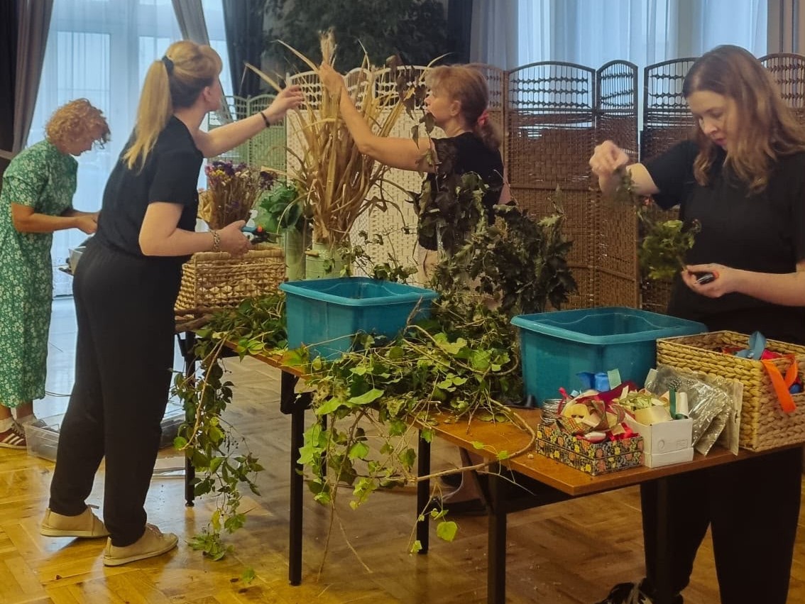 kobiety robiące dekoracje z różnych roślinnych elementów